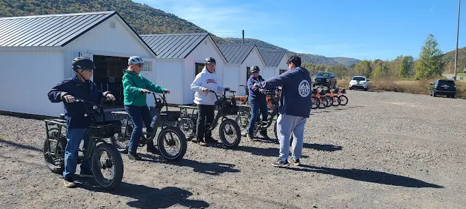 Riders receiving a quick e-bike orientation outside Tioga Wilds before heading to the Pine Creek Rail Trail
