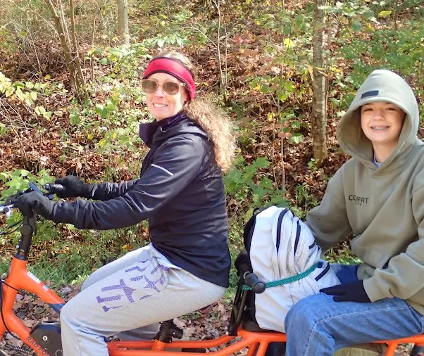 Family enjoying a ride on electric bikes along the Pine Creek Rail Trail in Pennsylvania