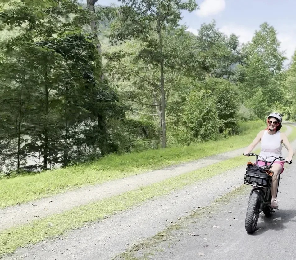 Rider cruising on an e-bike along the scenic Pine Creek Rail Trail near Wellsboro, PA