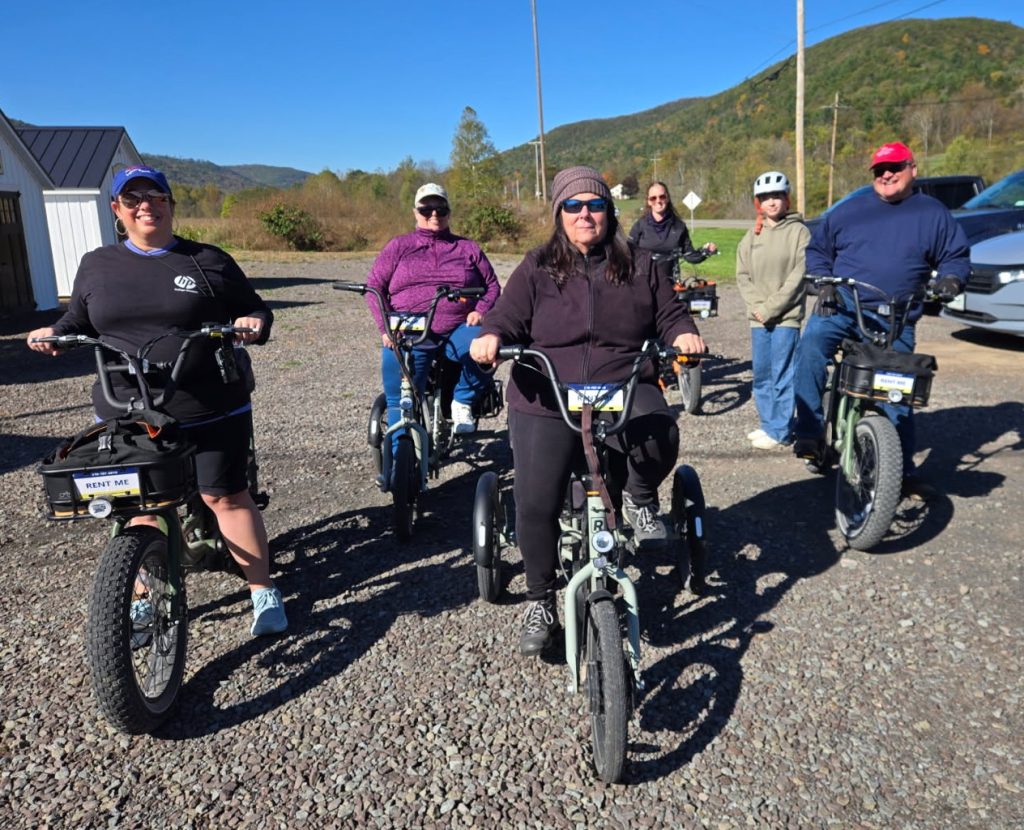Group of riders on electric bikes outside Tioga Wilds near the Pine Creek Rail Trail in Wellsboro, PA